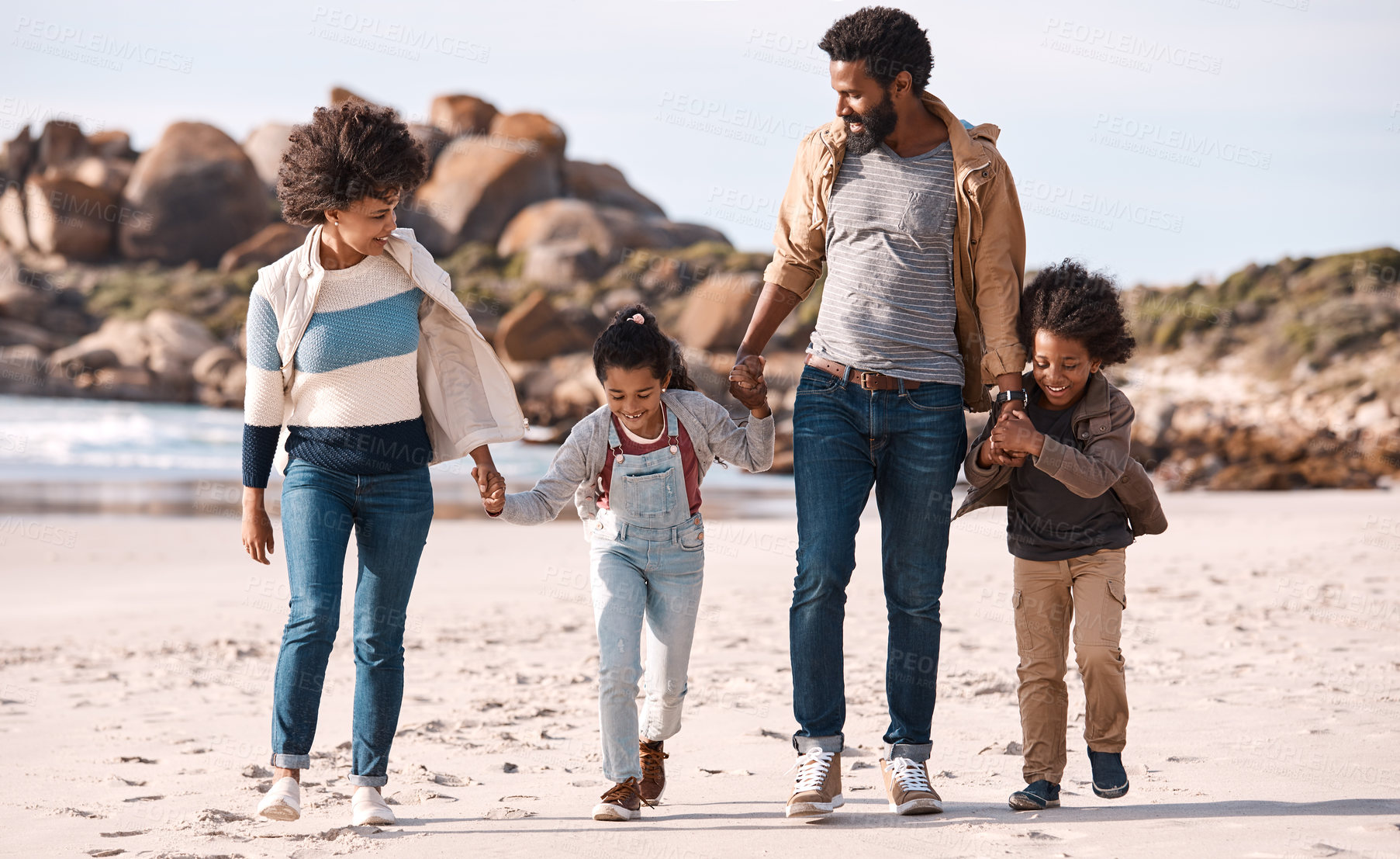 Buy stock photo Shot of an adorable little boy and girl going having fun at the beach with their parents