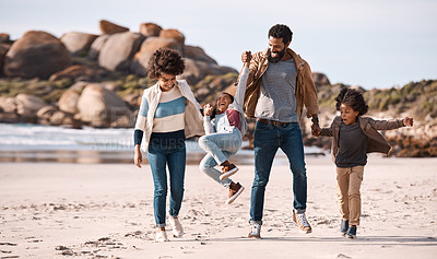 Buy stock photo Shot of an adorable little boy and girl going having fun at the beach with their parents