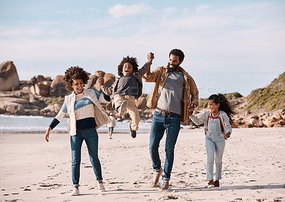 Buy stock photo Shot of an adorable little boy and girl going having fun at the beach with their parents