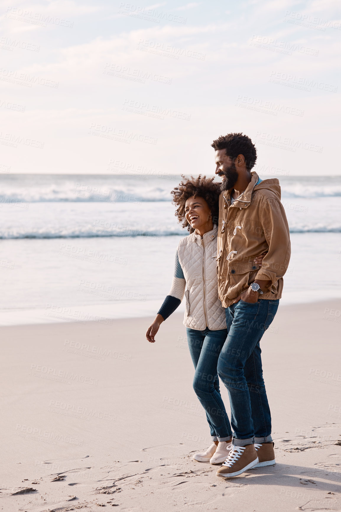 Buy stock photo Happiness, couple and walking on beach for travel, support or bonding with humor on coast. Black people, laughing and healthy relationship with space, connection and exploring on seaside stroll