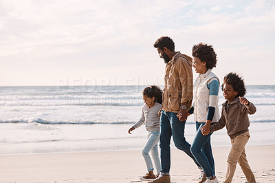 Buy stock photo Shot of an adorable little boy and girl going for a walk along the beach with their parents