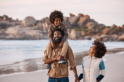 Buy stock photo Shot of a happy young family going for a walk along the beach