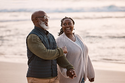Buy stock photo Shot of a happy mature couple going for a romantic walk along the beach