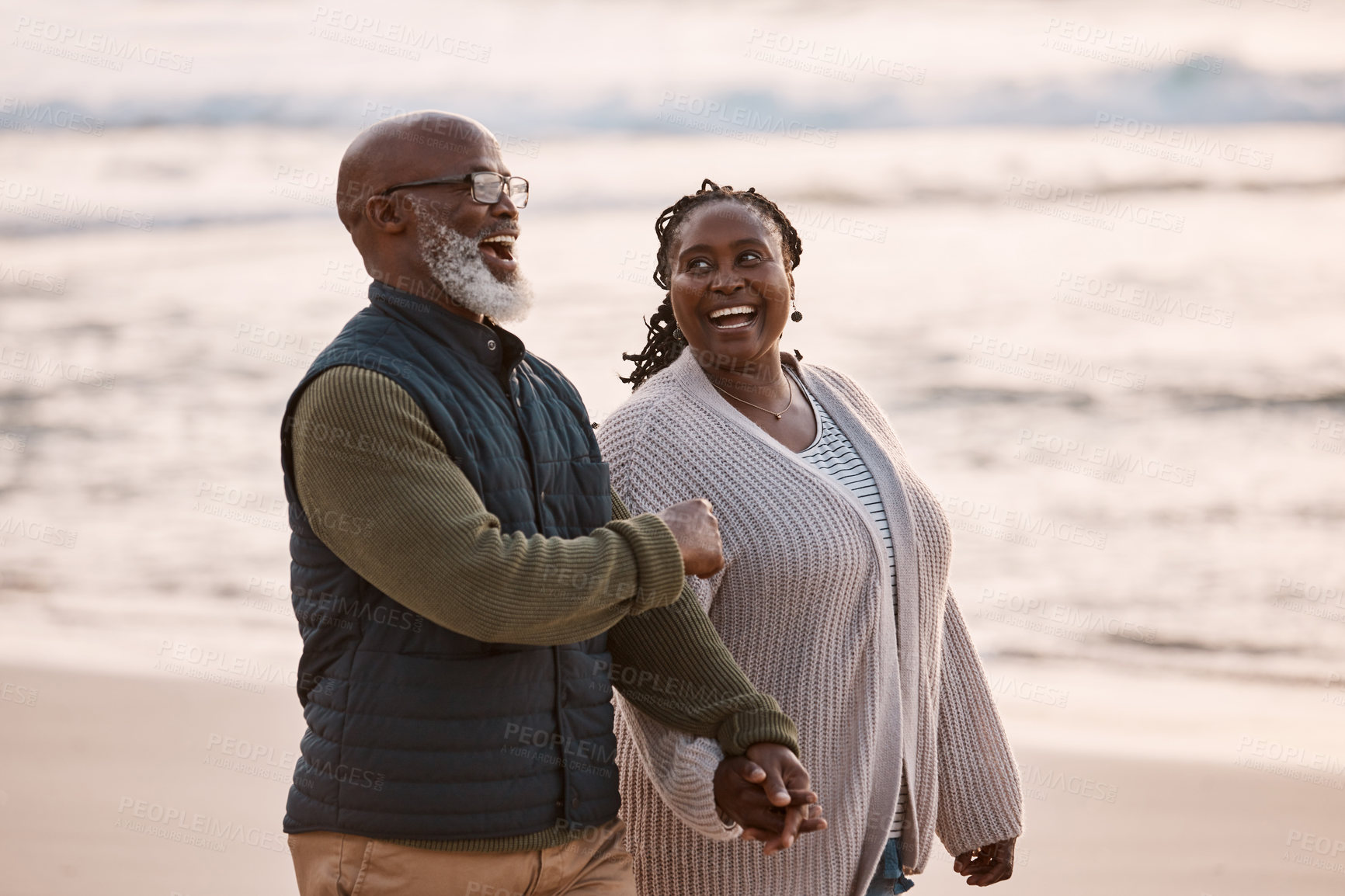 Buy stock photo Shot of a happy mature couple going for a romantic walk along the beach