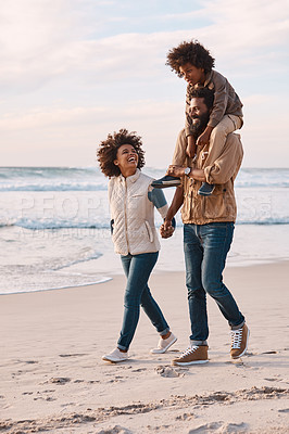 Buy stock photo Shot of a happy young family going for a walk along the beach