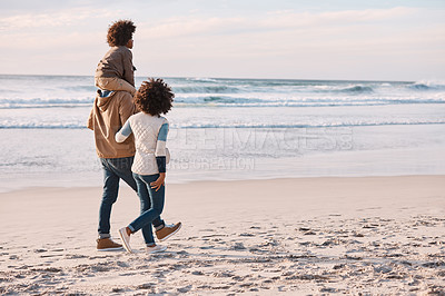 Buy stock photo Shot of a happy young family going for a walk along the beach