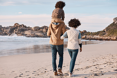 Buy stock photo Shot of a happy young family going for a walk along the beach