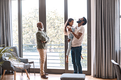 Buy stock photo Full length shot of an adorable little girl spending time with her father and grandfather at home