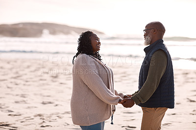 Buy stock photo Shot of a happy mature couple spending a romantic day at the beach