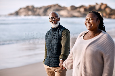 Buy stock photo Shot of a happy mature couple going for a romantic walk along the beach