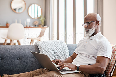 Buy stock photo Shot of a mature man using a laptop at home