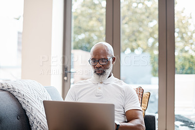 Buy stock photo Shot of a mature man using a laptop at home