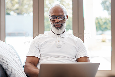 Buy stock photo Shot of a mature man using a laptop at home