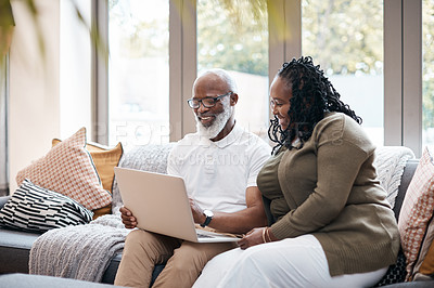 Buy stock photo Shot of a mature couple using a laptop together at home