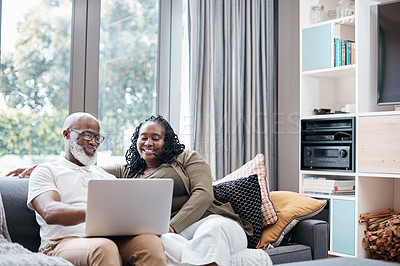 Buy stock photo Shot of a mature couple using a laptop together at home