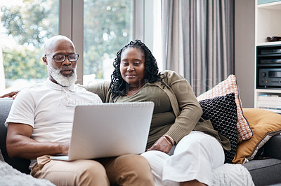 Buy stock photo Shot of a mature couple using a laptop together at home