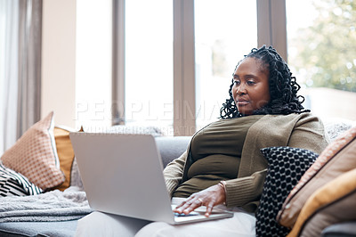 Buy stock photo Shot of a mature woman using a laptop at home