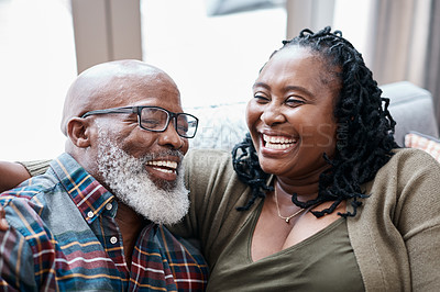 Buy stock photo Shot of a mature couple relaxing together on a sofa at home