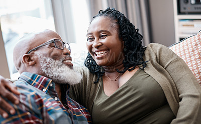 Buy stock photo Shot of a mature couple relaxing together on a sofa at home