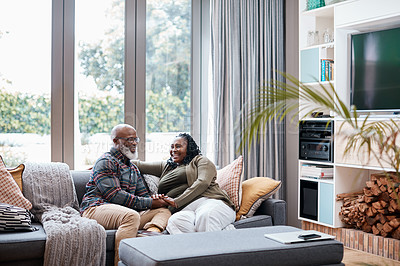 Buy stock photo Shot of a mature couple relaxing together on a sofa at home