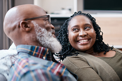 Buy stock photo Shot of a mature couple relaxing together on a sofa at home