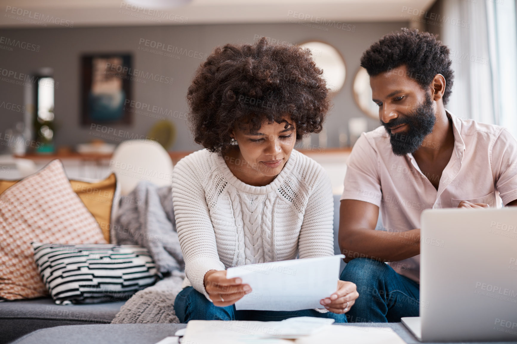 Buy stock photo Document, finance and couple in home for planning budget, tax discussion or expense tracking. African man, happy woman and paper for house savings, payment info or review spending cost with laptop