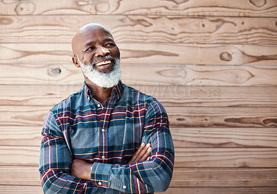 Buy stock photo Shot of a mature man looking thoughtful while standing against a brown background