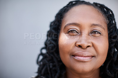 Buy stock photo Portrait of a mature woman standing against a grey background