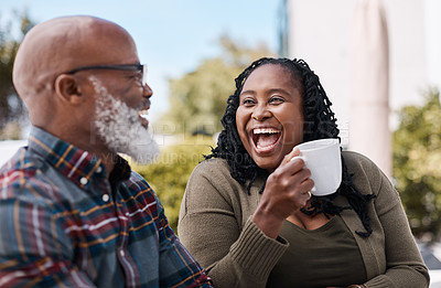 Buy stock photo Shot of a mature couple drinking coffee while having a chat outdoors