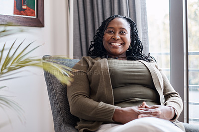 Buy stock photo Shot of a mature woman looking thoughtful while relaxing on a couch at home