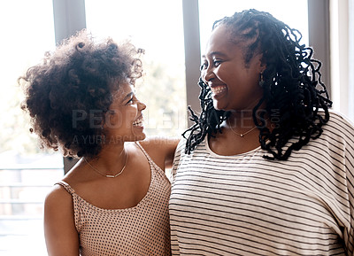 Buy stock photo Shot of a happy young woman bonding and spending time with her mother at home