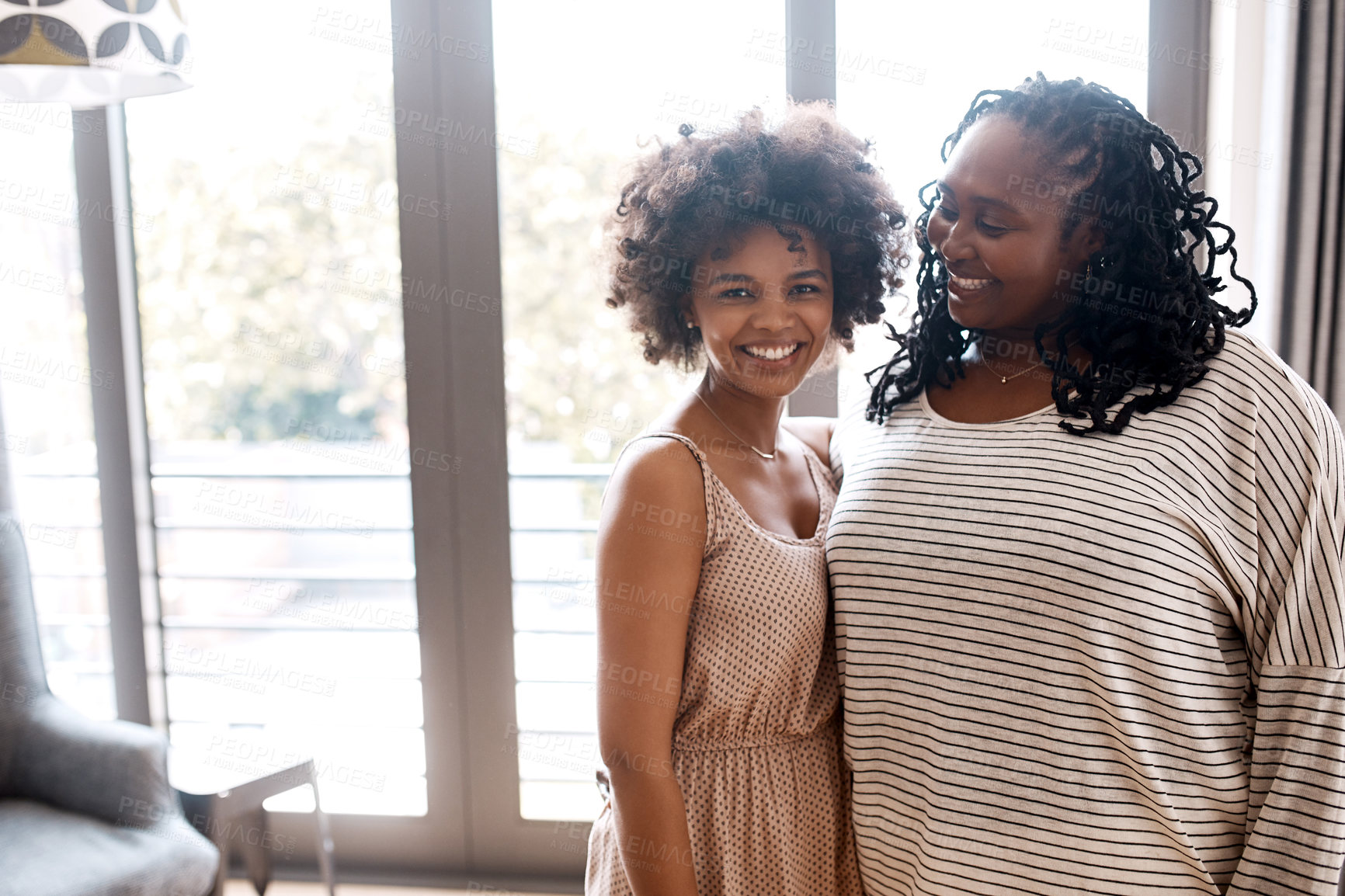 Buy stock photo Portrait of a happy young woman bonding and spending time with her mother at home