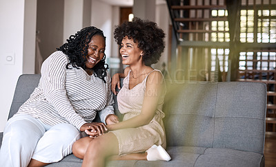 Buy stock photo Shot of a happy young woman bonding and spending time with her mother at home