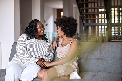 Buy stock photo Shot of a happy young woman bonding and spending time with her mother at home