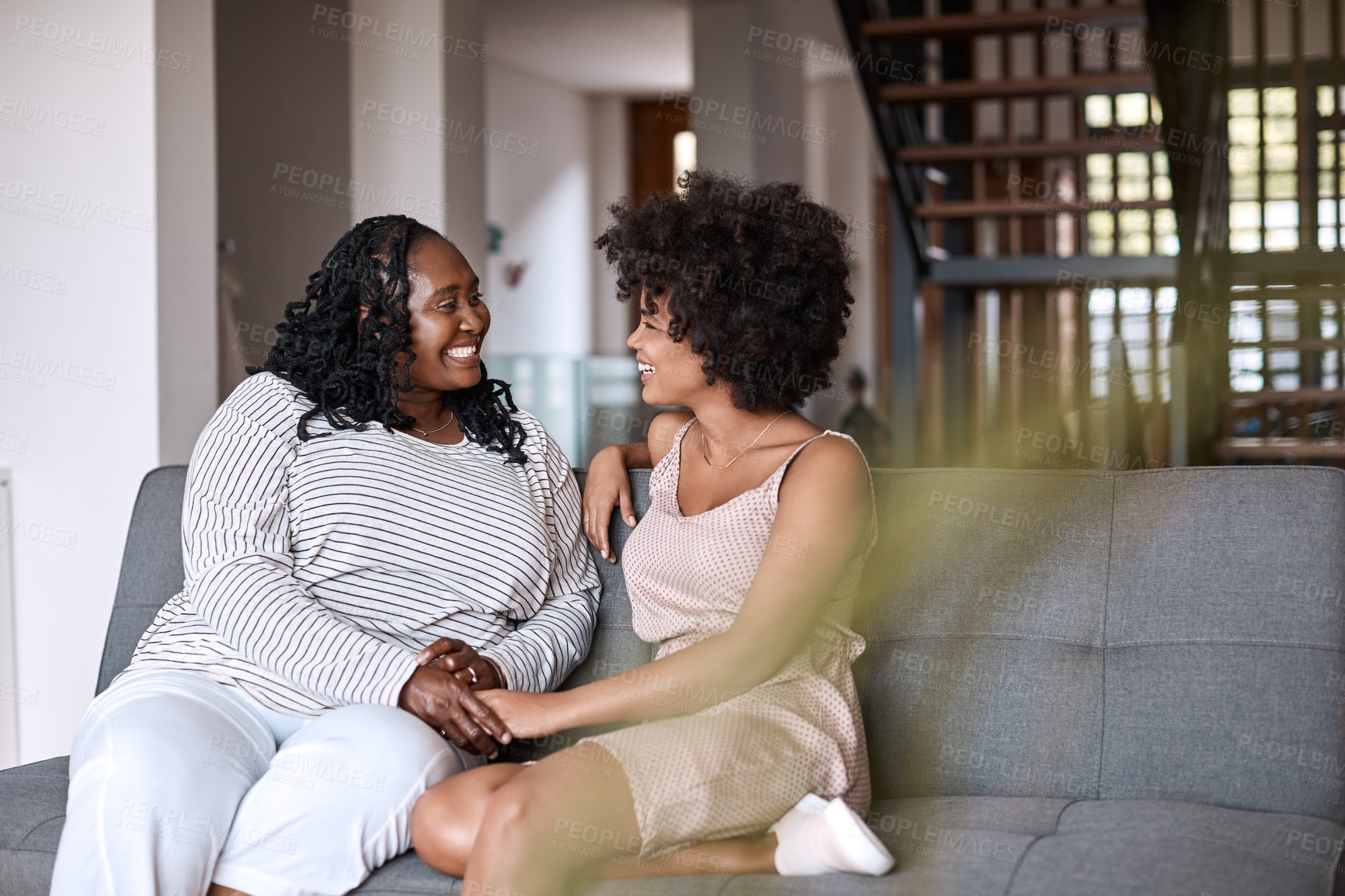 Buy stock photo Shot of a happy young woman bonding and spending time with her mother at home