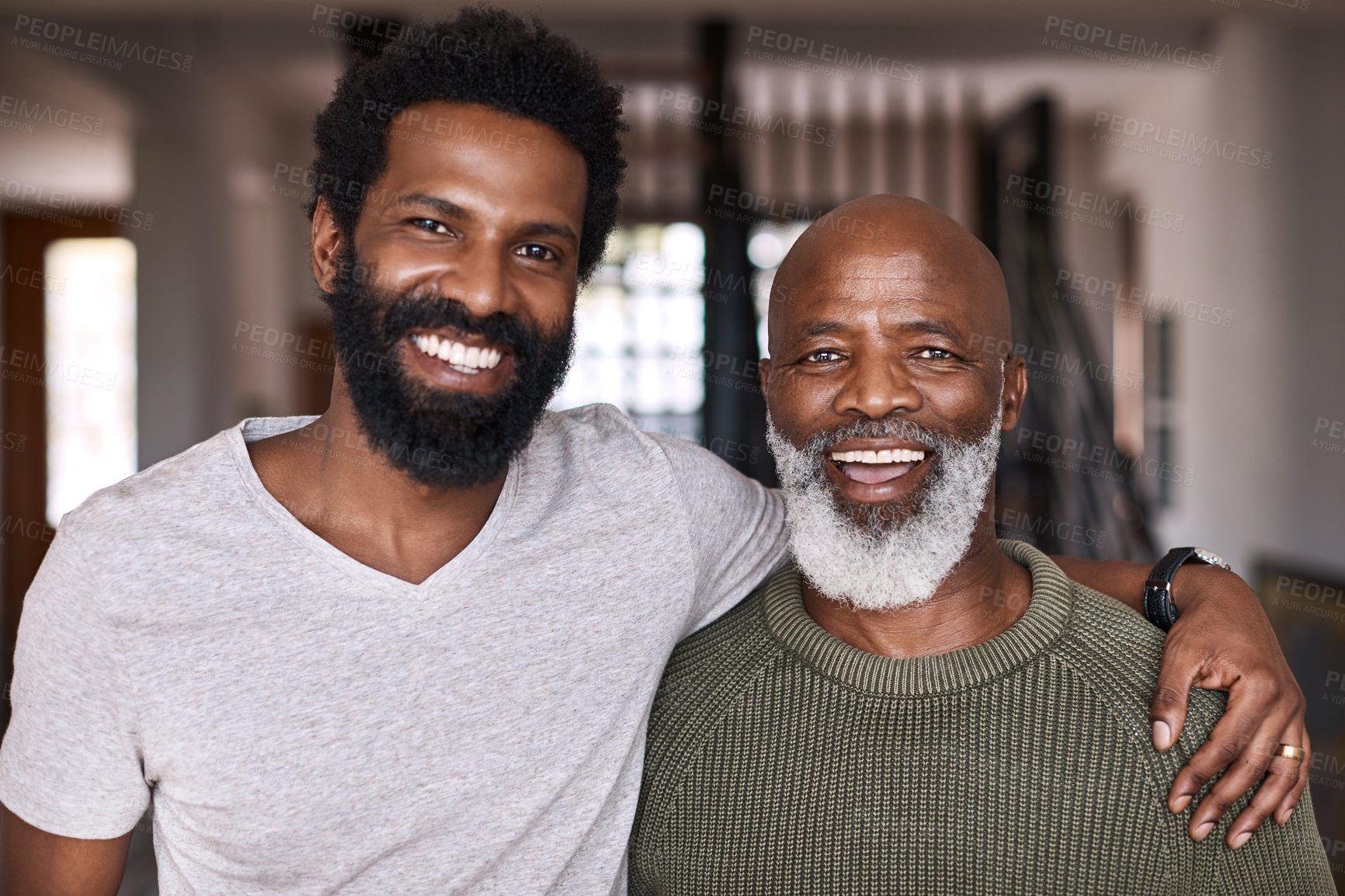 Buy stock photo Portrait of a happy young man relaxing and spending time with his father at home