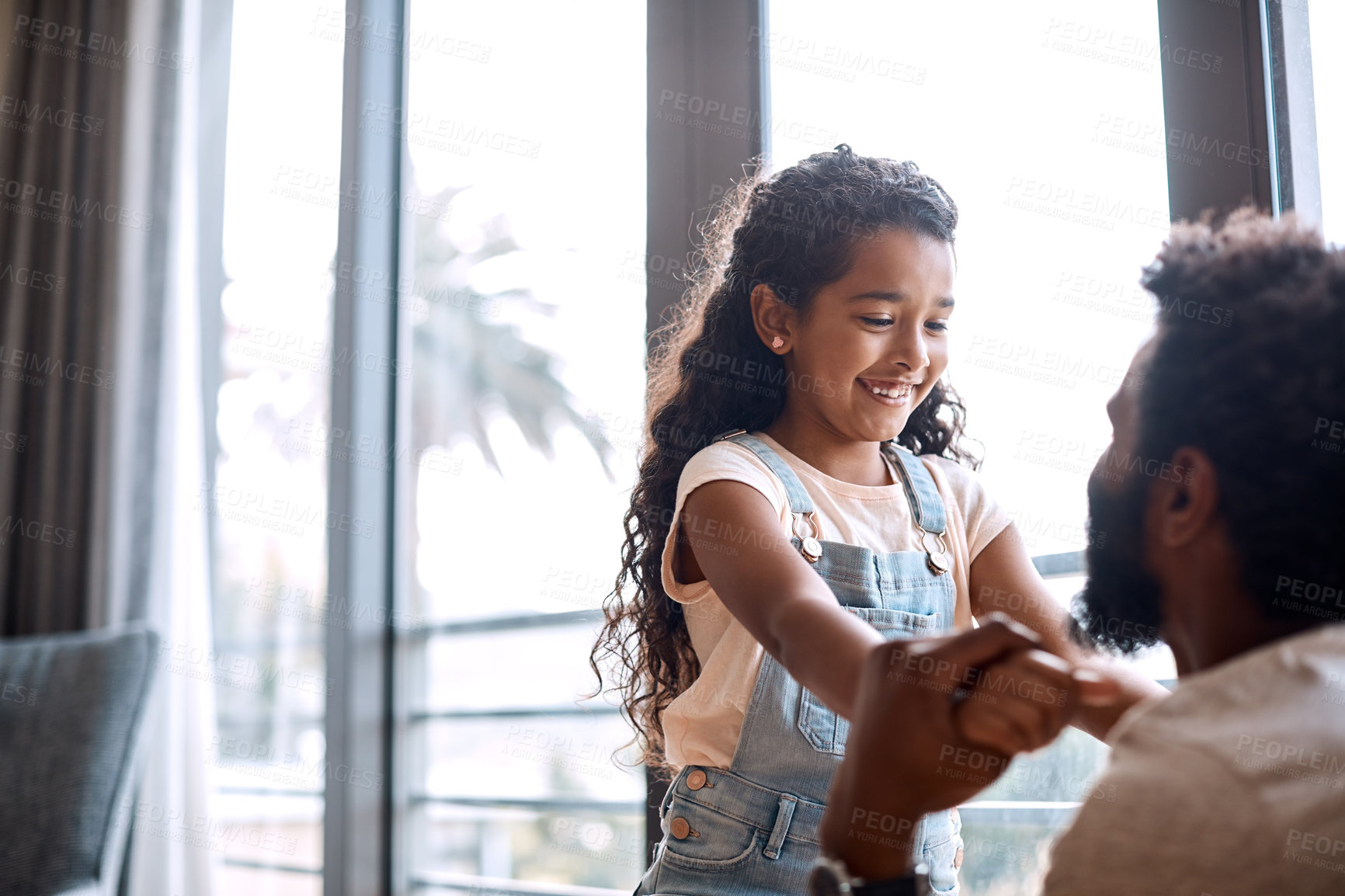 Buy stock photo Shot of an adorable little girl playing and spending time with her father at home