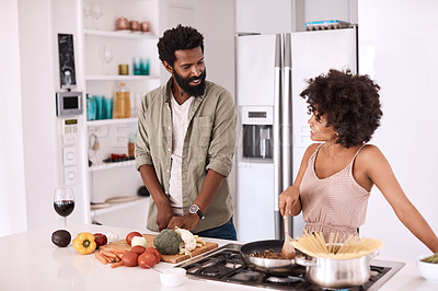 Buy stock photo Cropped shot of a couple cooking together in their kitchen