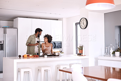 Buy stock photo Shot of a man talking to his wife while she cooks