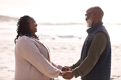 Buy stock photo Shot of a happy mature couple spending a romantic day at the beach
