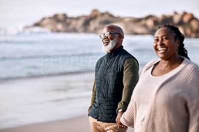 Buy stock photo Shot of a happy mature couple going for a romantic walk along the beach