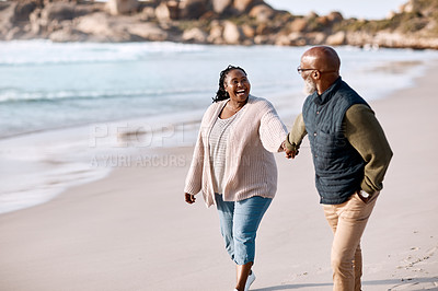 Buy stock photo Shot of a happy mature couple going for a romantic walk along the beach