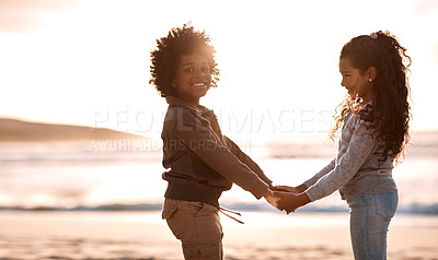 Buy stock photo Shot of an adorable little boy and girl having fun together at the beach