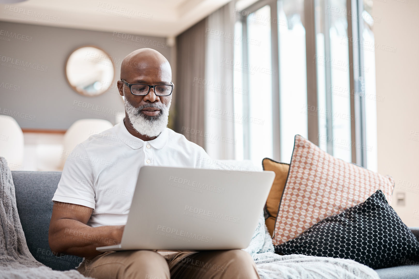 Buy stock photo Shot of a mature man using a laptop at home