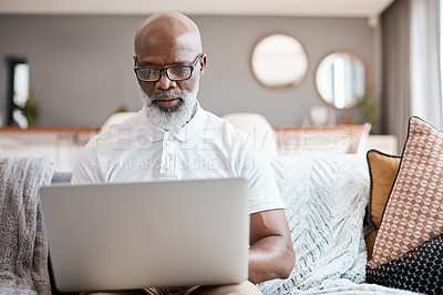 Buy stock photo Shot of a mature man using a laptop at home