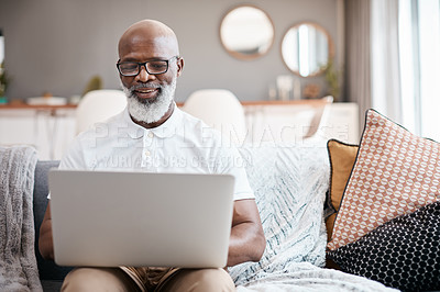 Buy stock photo Shot of a mature man using a laptop at home