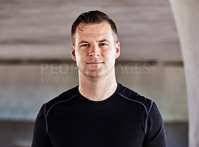 Buy stock photo Cropped portrait of a handsome young male athlete working out in the city