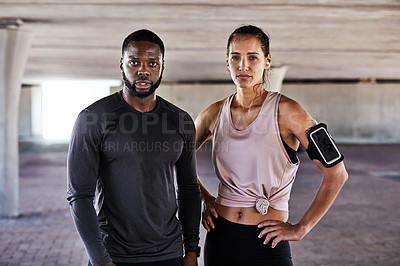 Buy stock photo Cropped portrait of two young athletes standing side by side while working out in the city