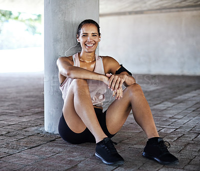 Buy stock photo Full length portrait of an attractive young female athlete taking a rest while working out in the city
