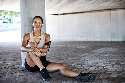 Buy stock photo Full length portrait of an attractive young female athlete taking a rest while working out in the city